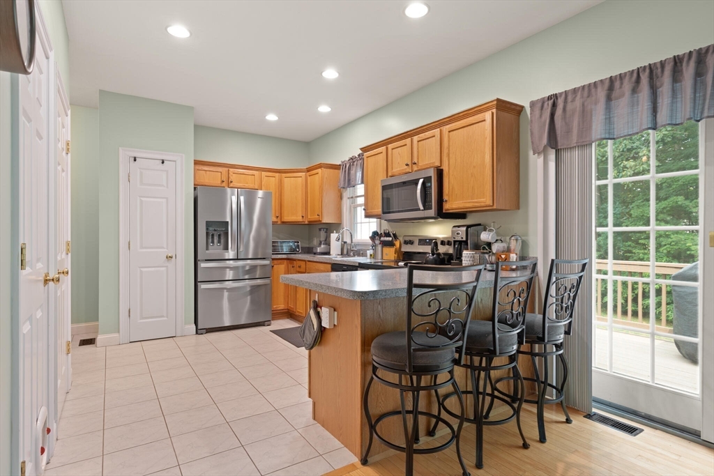 3 Knowlton Circle, Unit 3 Upton, MA 01568 - Photo 19 of 42 a kitchen with stainless steel appliances a refrigerator and a stove top oven