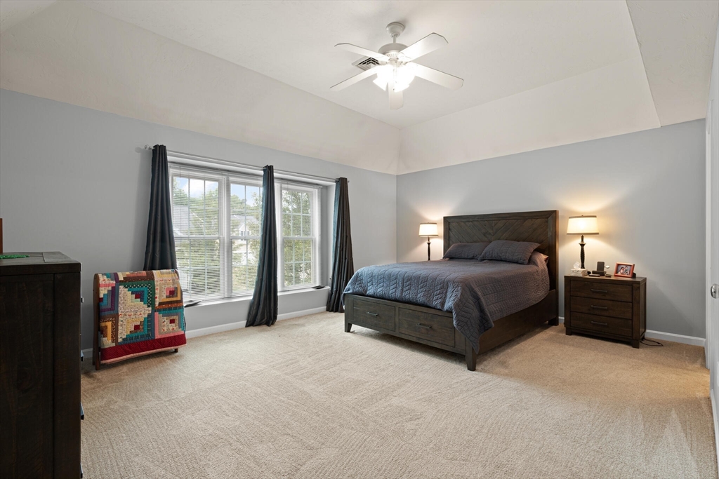 3 Knowlton Circle, Unit 3 Upton, MA 01568 - Photo 24 of 42 a bedroom with a bed and a chandelier