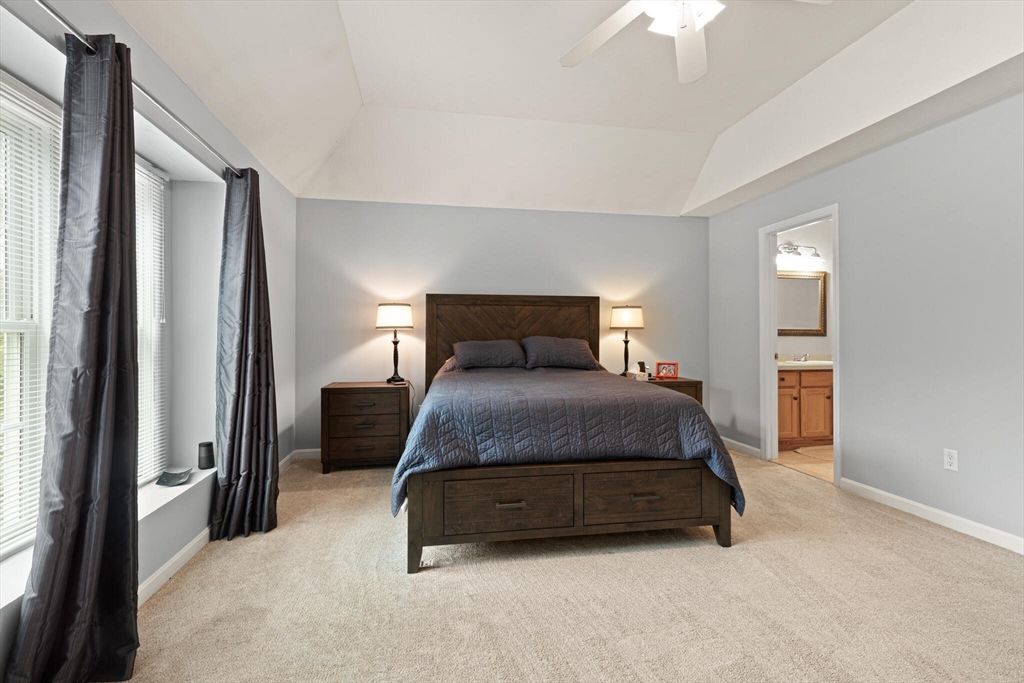 3 Knowlton Circle, Unit 3 Upton, MA 01568 - Photo 25 of 42 a bedroom with a bed and a chandelier