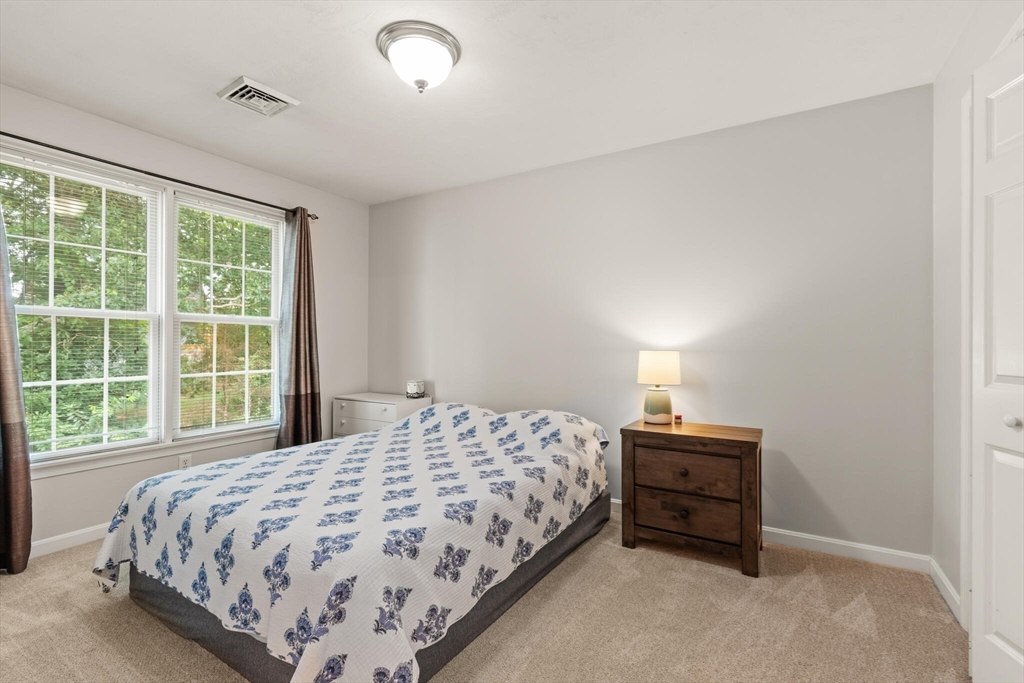 3 Knowlton Circle, Unit 3 Upton, MA 01568 - Photo 28 of 42 a bedroom with a bed and a window