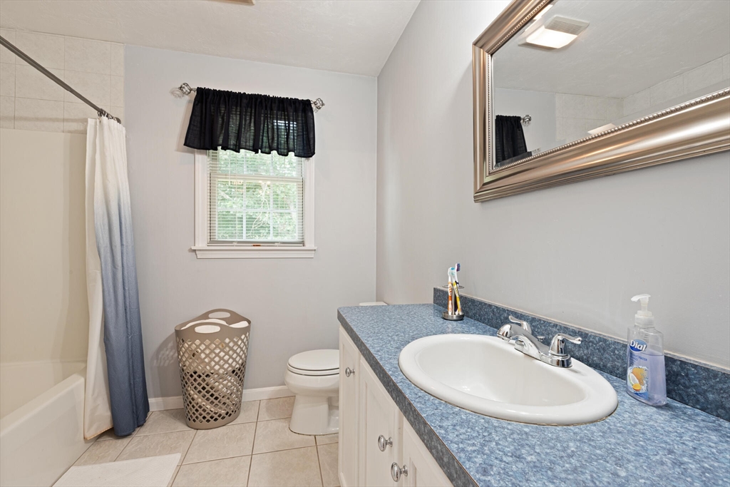 3 Knowlton Circle, Unit 3 Upton, MA 01568 - Photo 29 of 42 a bathroom with a granite countertop sink a toilet and mirror