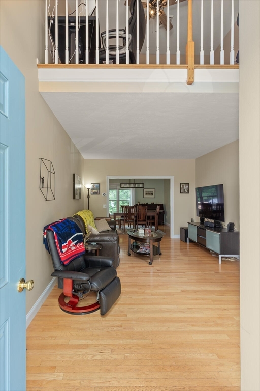 3 Knowlton Circle, Unit 3 Upton, MA 01568 - Photo 7 of 42 a living room with furniture a flat screen tv and a large window