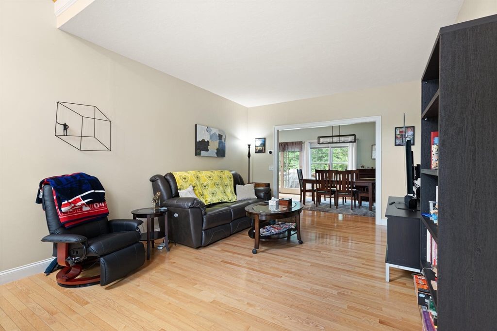 3 Knowlton Circle, Unit 3 Upton, MA 01568 - Photo 8 of 42 a living room with furniture and a flat screen tv