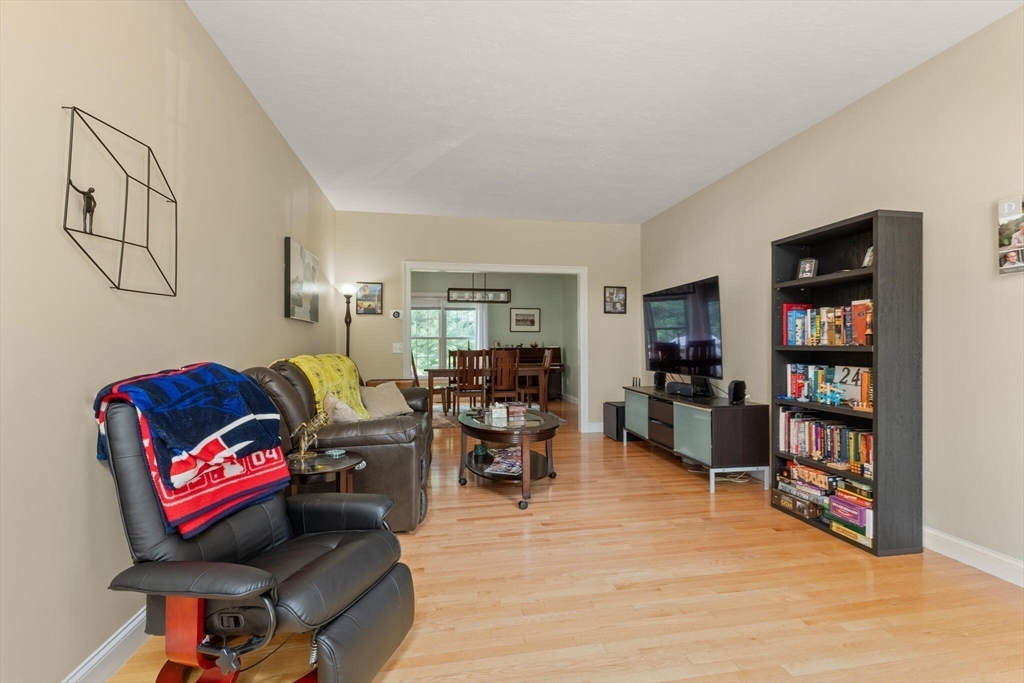 3 Knowlton Circle, Unit 3 Upton, MA 01568 - Photo 9 of 42 a living room with furniture and a bookshelf