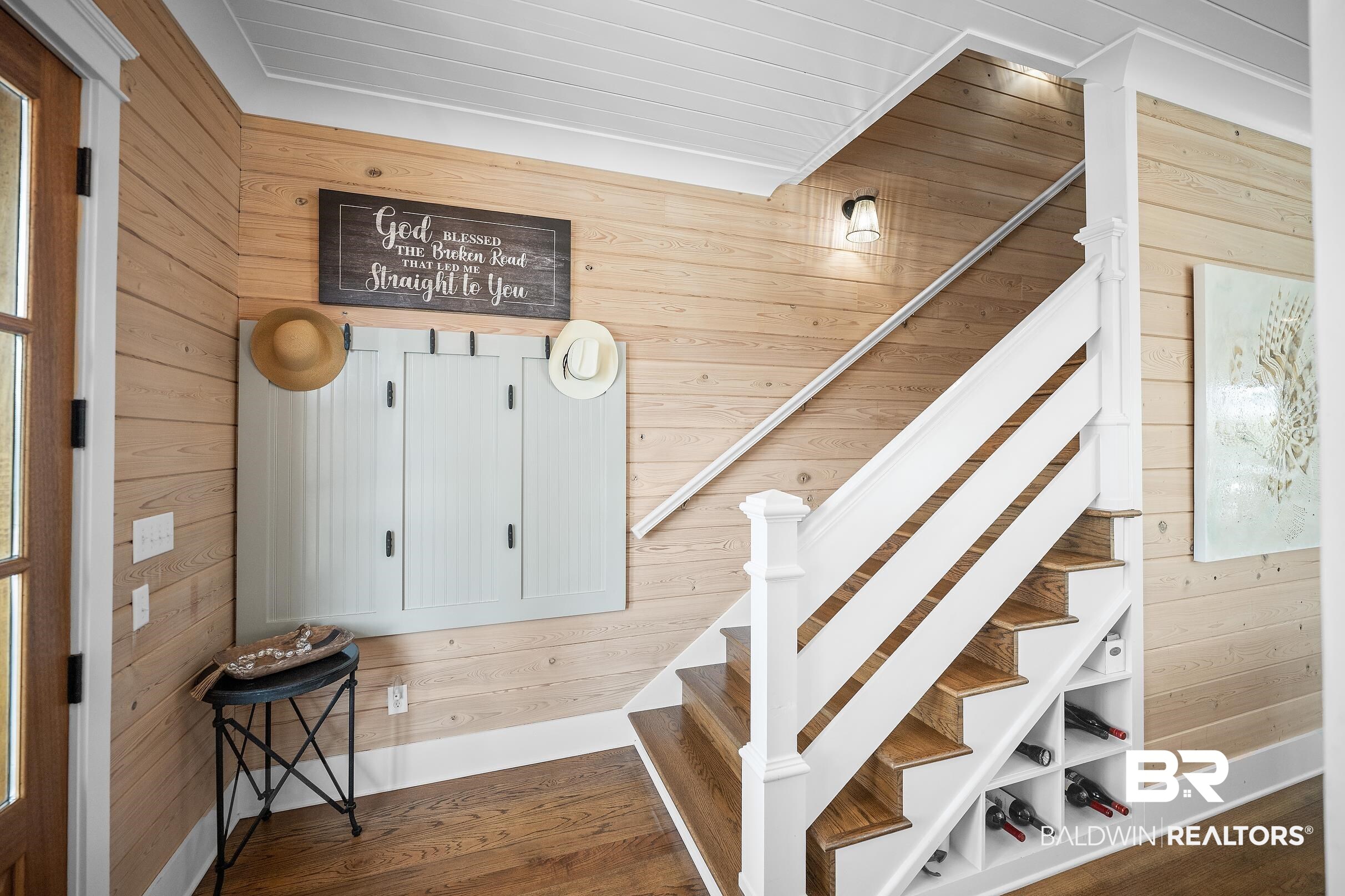 33186 Marlin Key Drive Orange Beach, AL 36561 - Photo 58 of 87 Staircase with wooden walls and wood finished floors