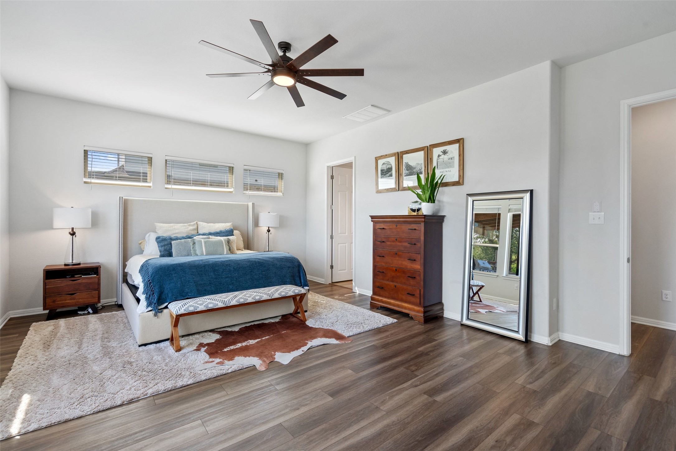 162 Lunar Loop Austin, TX 78737 - Photo 13 of 40 a bedroom with a bed and a chandelier