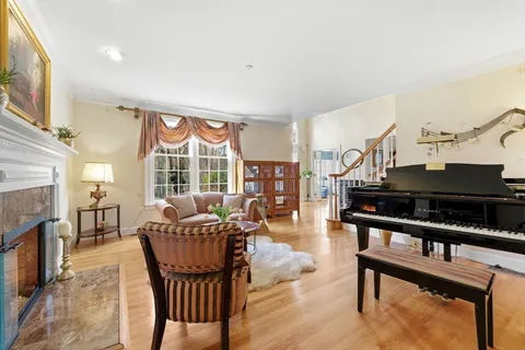 a living room with furniture a fireplace and a large window
