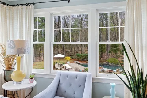 a living room with furniture and a large window