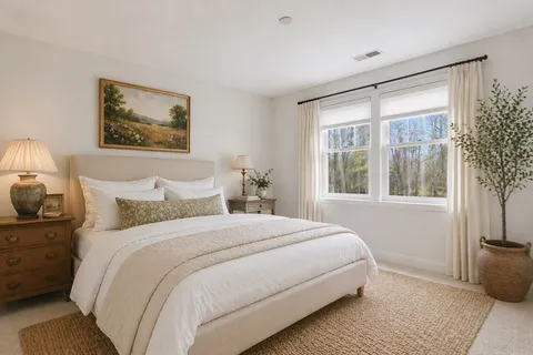 a bedroom with bed and a window