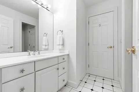 a bathroom with a shower sink and mirror