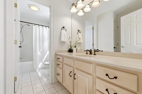 a bathroom with a double vanity sink mirror and shower