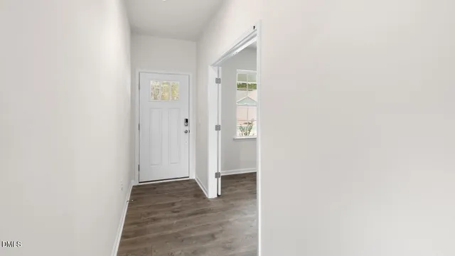 a kitchen with stainless steel appliances a sink a stove a refrigerator cabinets and a large window