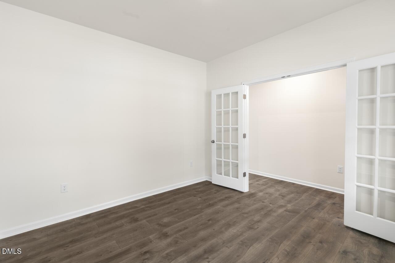 1253 Pavo Path Wendell, NC 27591 - Photo 8 of 41 an empty room with wooden floor and white walls