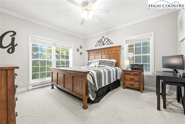 a bedroom with a bed chair and a large window