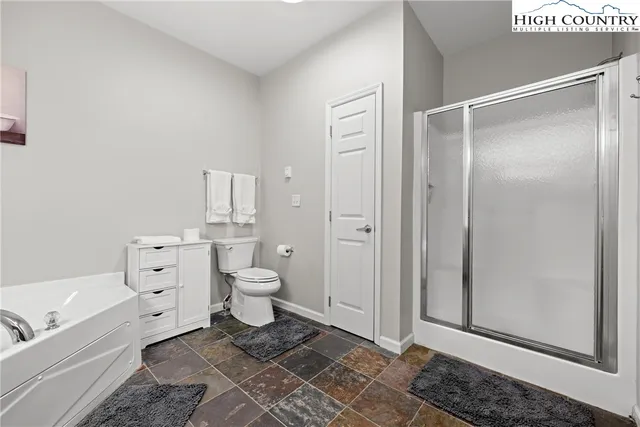 a bathroom with a toilet a sink and shower