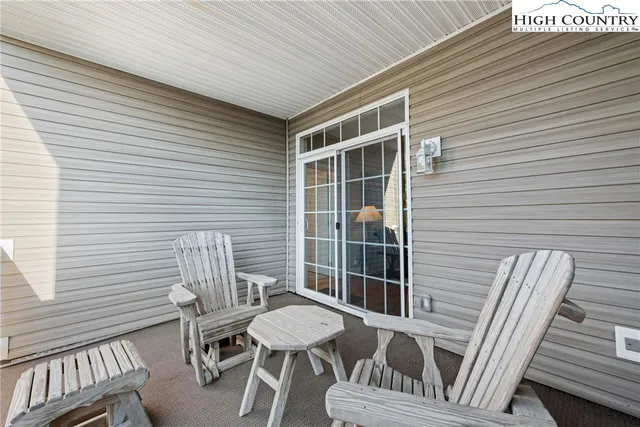 a balcony with table and chairs
