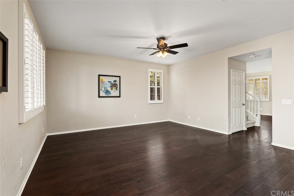 46945 Peach Tree Street Temecula, CA 92592 - Photo 11 of 32 a view of an empty room with a window and wooden floor