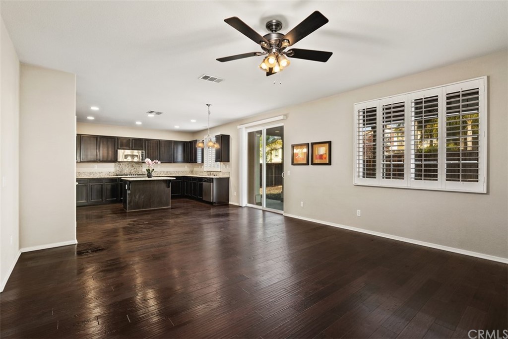 46945 Peach Tree Street Temecula, CA 92592 - Photo 13 of 32 a view of an empty room with wooden floor and a window