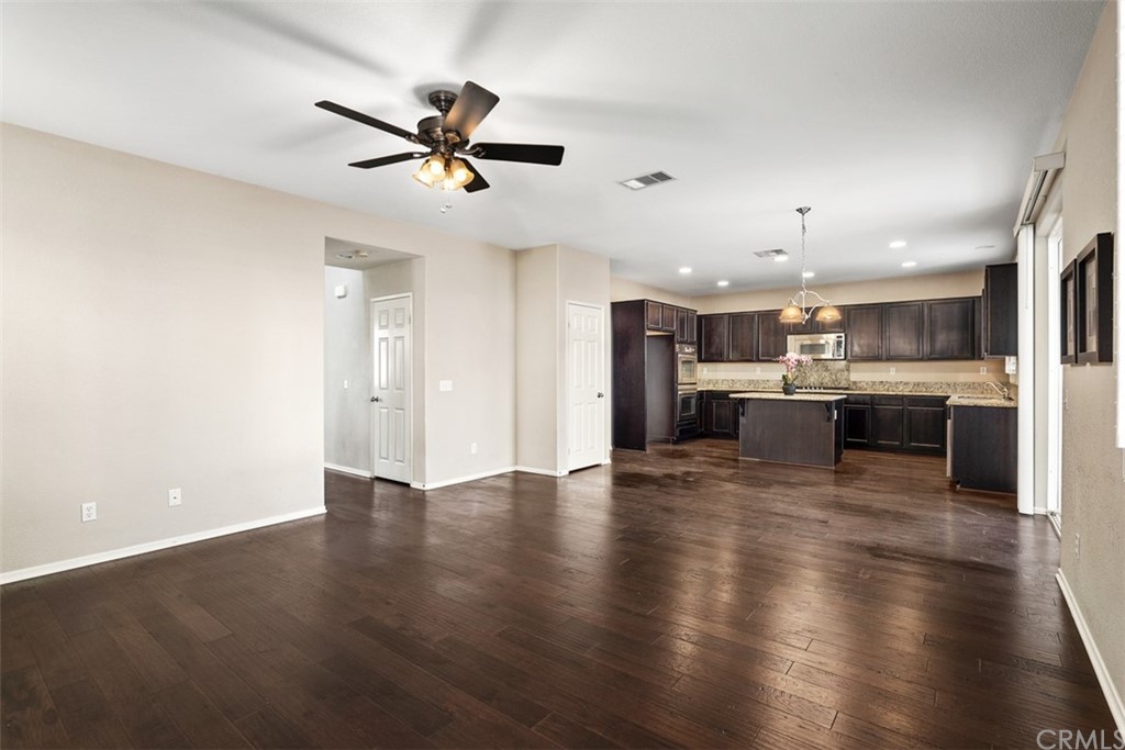 46945 Peach Tree Street Temecula, CA 92592 - Photo 14 of 32 a view of kitchen with refrigerator stove and wooden floor