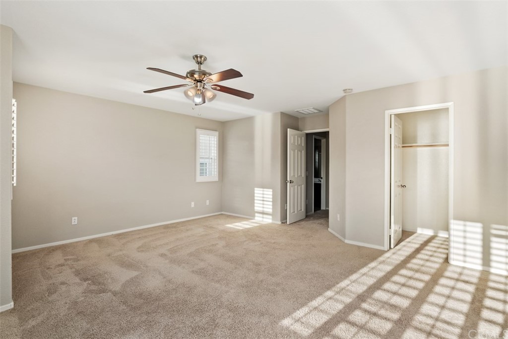 46945 Peach Tree Street Temecula, CA 92592 - Photo 18 of 32 a view of a room with a ceiling fan and a window