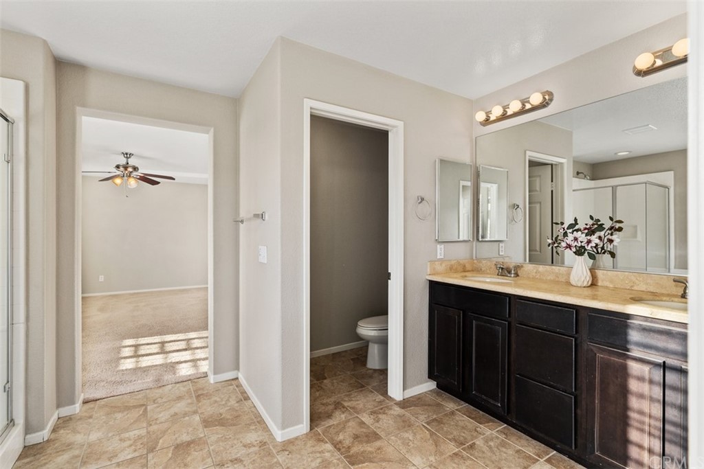 46945 Peach Tree Street Temecula, CA 92592 - Photo 20 of 32 a bathroom with a double vanity sink toilet and shower