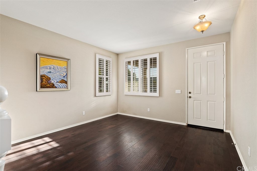 46945 Peach Tree Street Temecula, CA 92592 - Photo 5 of 32 a view of an empty room with a window and wooden floor