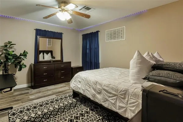a bedroom with a bed and a dresser