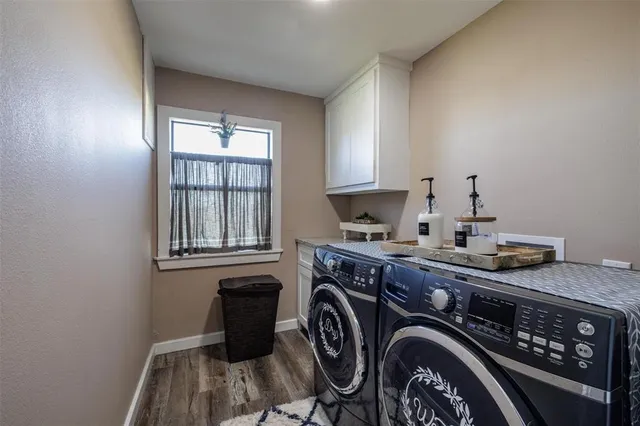 a utility room with sink dryer and washer