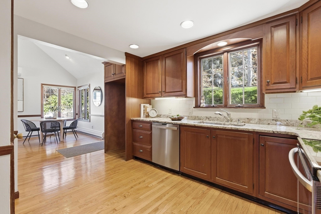 38 Morgan Avenue Wakefield, MA 01880 - Photo 11 of 39 a kitchen with stainless steel appliances granite countertop wooden cabinets a sink a stove a dining table and chairs