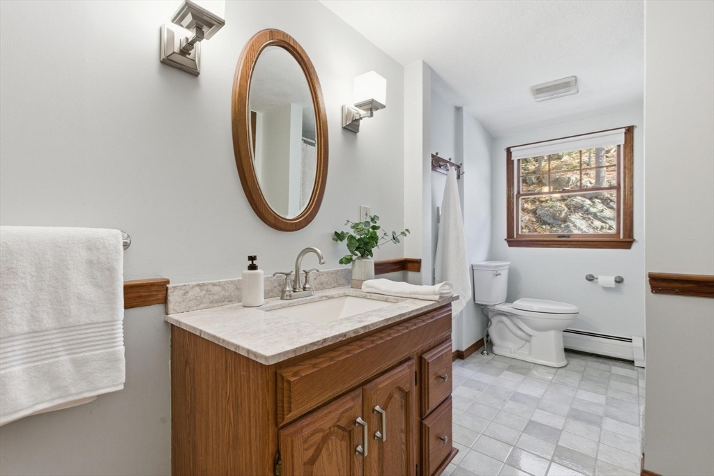 38 Morgan Avenue Wakefield, MA 01880 - Photo 27 of 39 a bathroom with a toilet sink and mirror