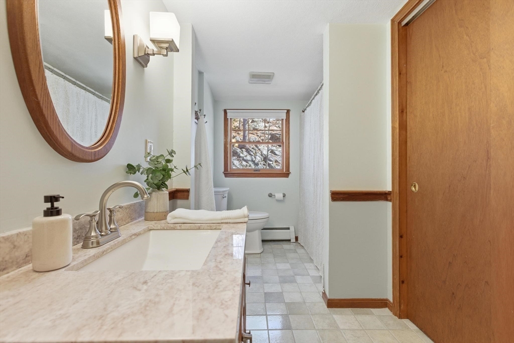 38 Morgan Avenue Wakefield, MA 01880 - Photo 28 of 39 a bathroom with a tub sink and mirror