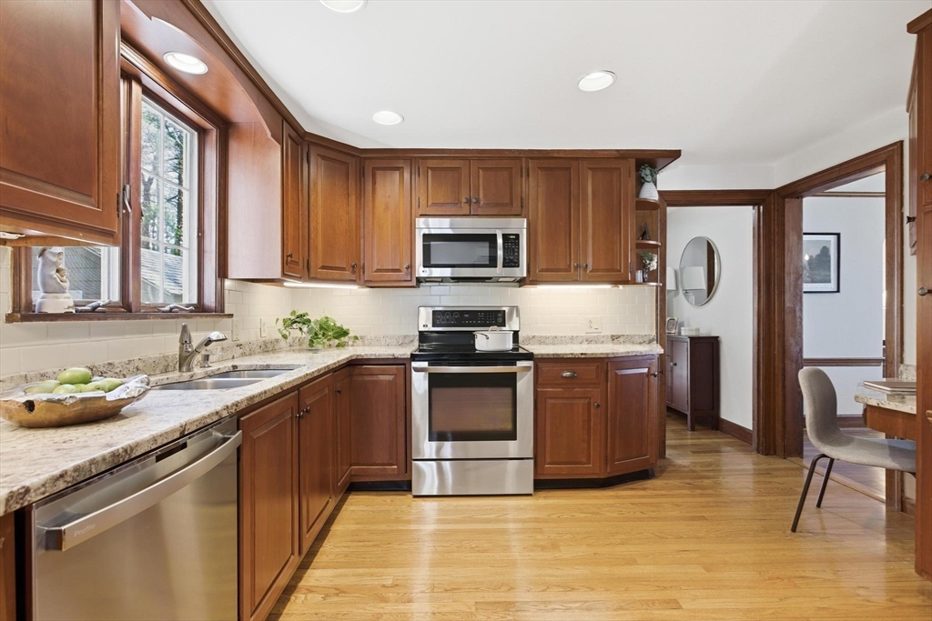 38 Morgan Avenue Wakefield, MA 01880 - Photo 9 of 39 a kitchen with granite countertop a stove top oven a sink and a microwave