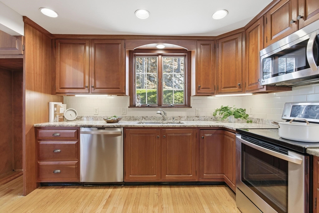 38 Morgan Avenue Wakefield, MA 01880 - Photo 10 of 39 a kitchen with granite countertop cabinets stainless steel appliances a sink and window