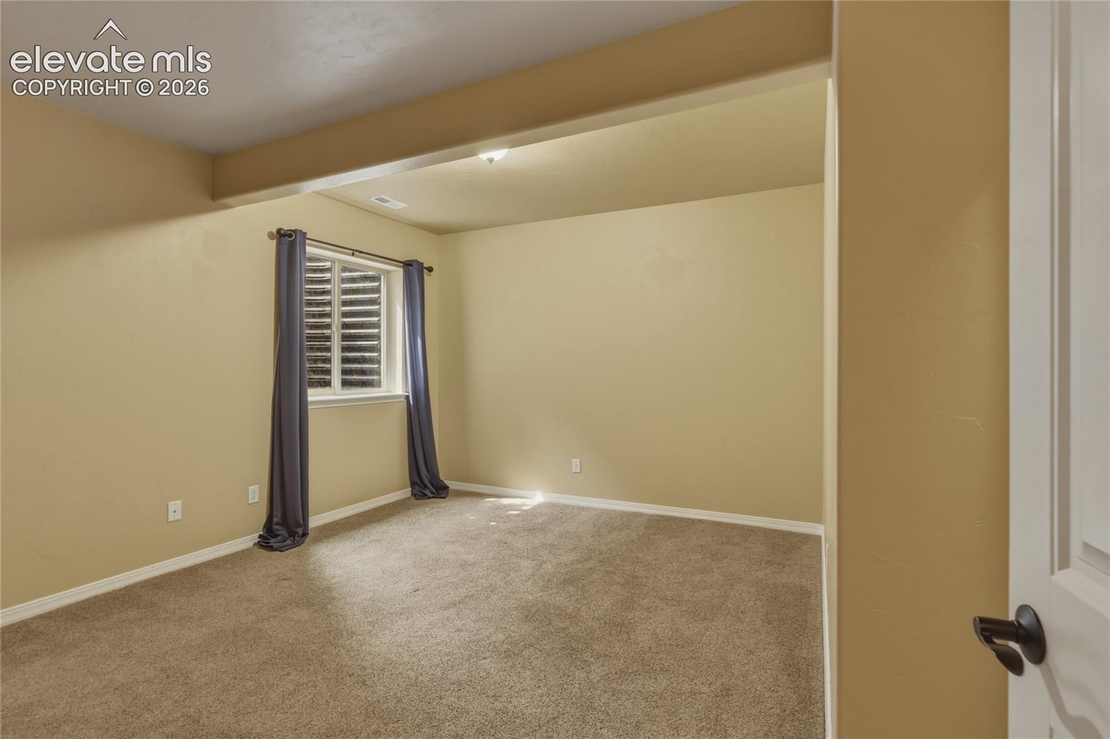 1118 Spectrum Loop Colorado Springs, CO 80921 - Photo 32 of 50 Recessed lighting illuminates this carpeted room, featuring a window with integrated louvered blinds