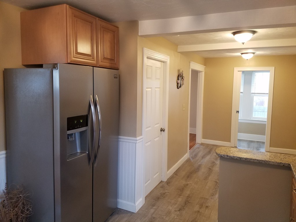 5 Lyndale Road Worcester, MA 01606 - Photo 6 of 22 a view of a refrigerator in kitchen and wooden floor