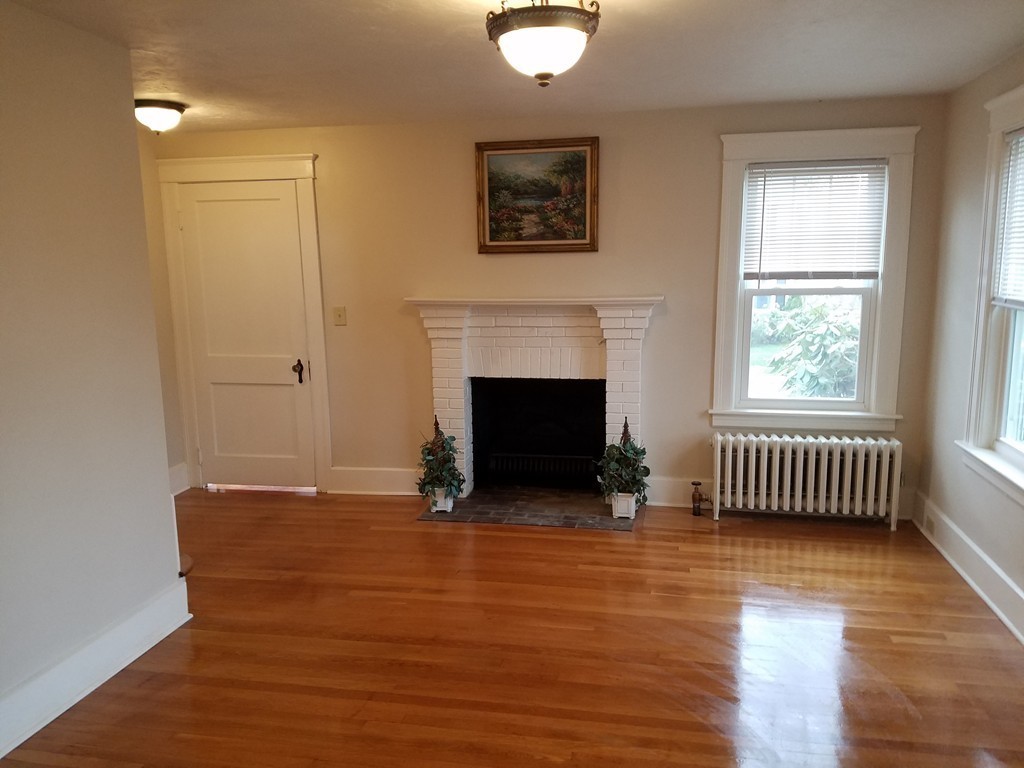 5 Lyndale Road Worcester, MA 01606 - Photo 8 of 22 wooden floor fireplace and windows in an empty room