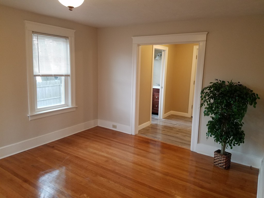5 Lyndale Road Worcester, MA 01606 - Photo 9 of 22 an empty room with wooden floor and a window