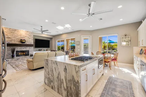 a kitchen with stainless steel appliances granite countertop a sink and cabinets