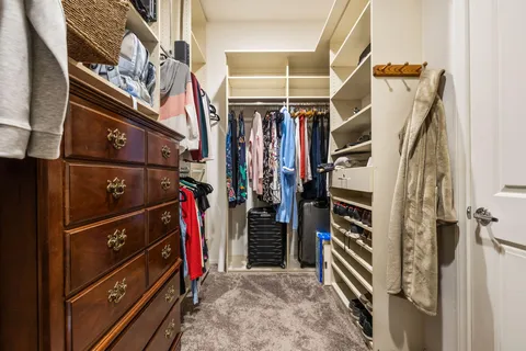 a bedroom with a bed and glass door