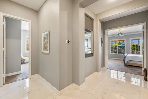a living room with furniture a flat screen tv and a floor to ceiling window