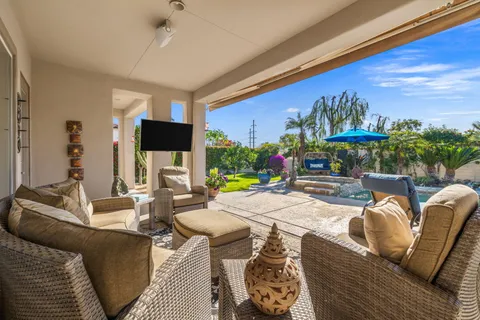 a view of a house with backyard porch and sitting area