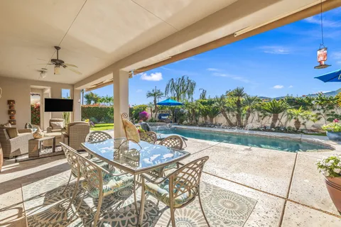 a view of a brick house with a flower garden
