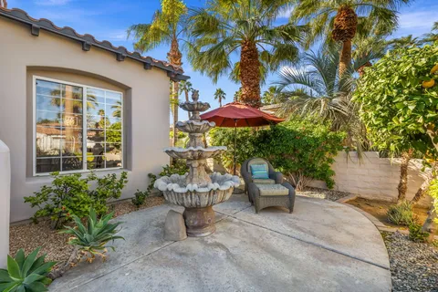 a view of a hallway with wooden floor and windows