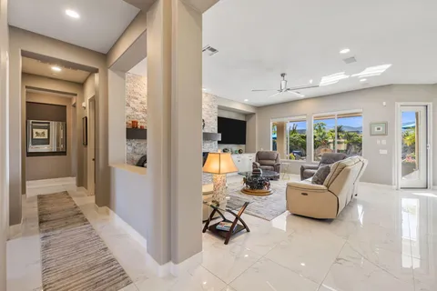 a living room with furniture fireplace and flat screen tv