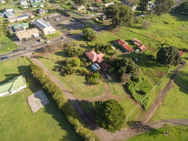 an aerial view of a house with a yard swimming pool
