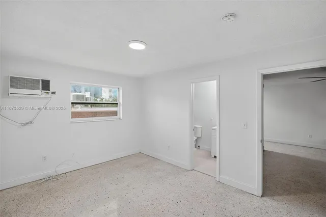 a view of an empty room with a window