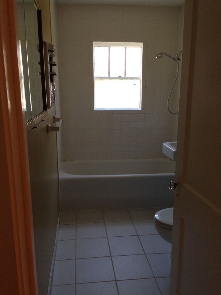 1719 Dunlavy Street Houston, TX 77006 - Photo 11 of 16 a bathroom with a granite countertop toilet a sink and shower