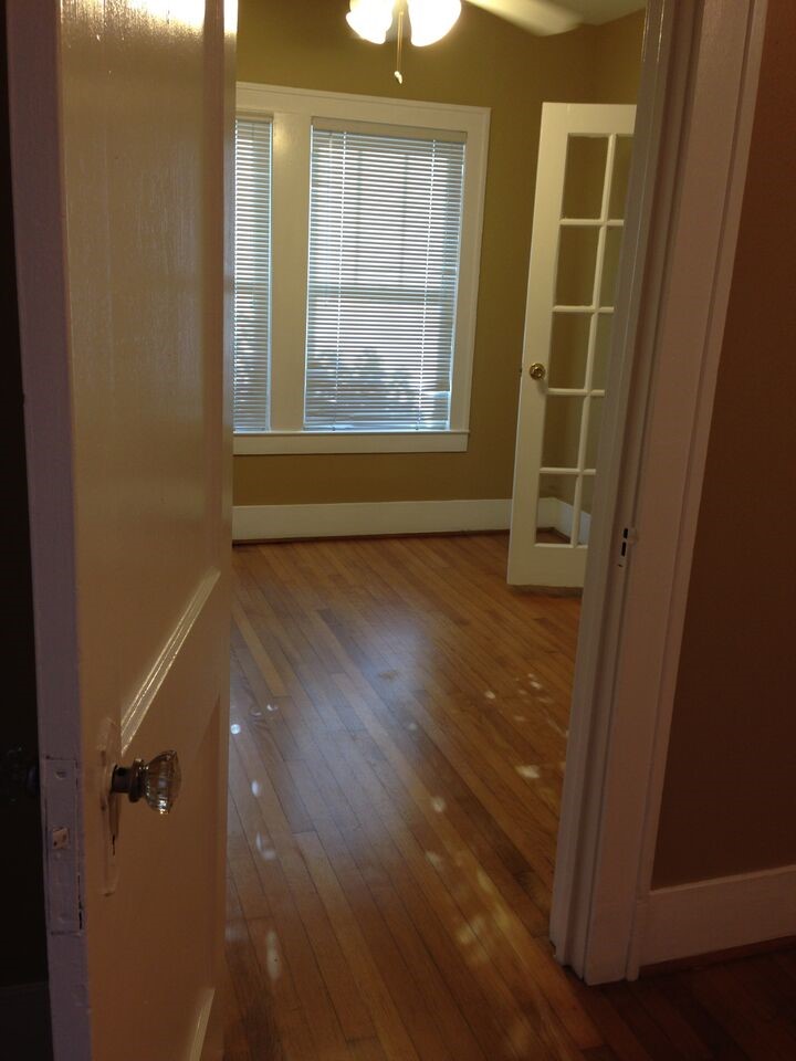 1719 Dunlavy Street Houston, TX 77006 - Photo 7 of 16 an empty room with wooden floor and windows