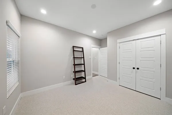 an empty room with window and ceiling fan