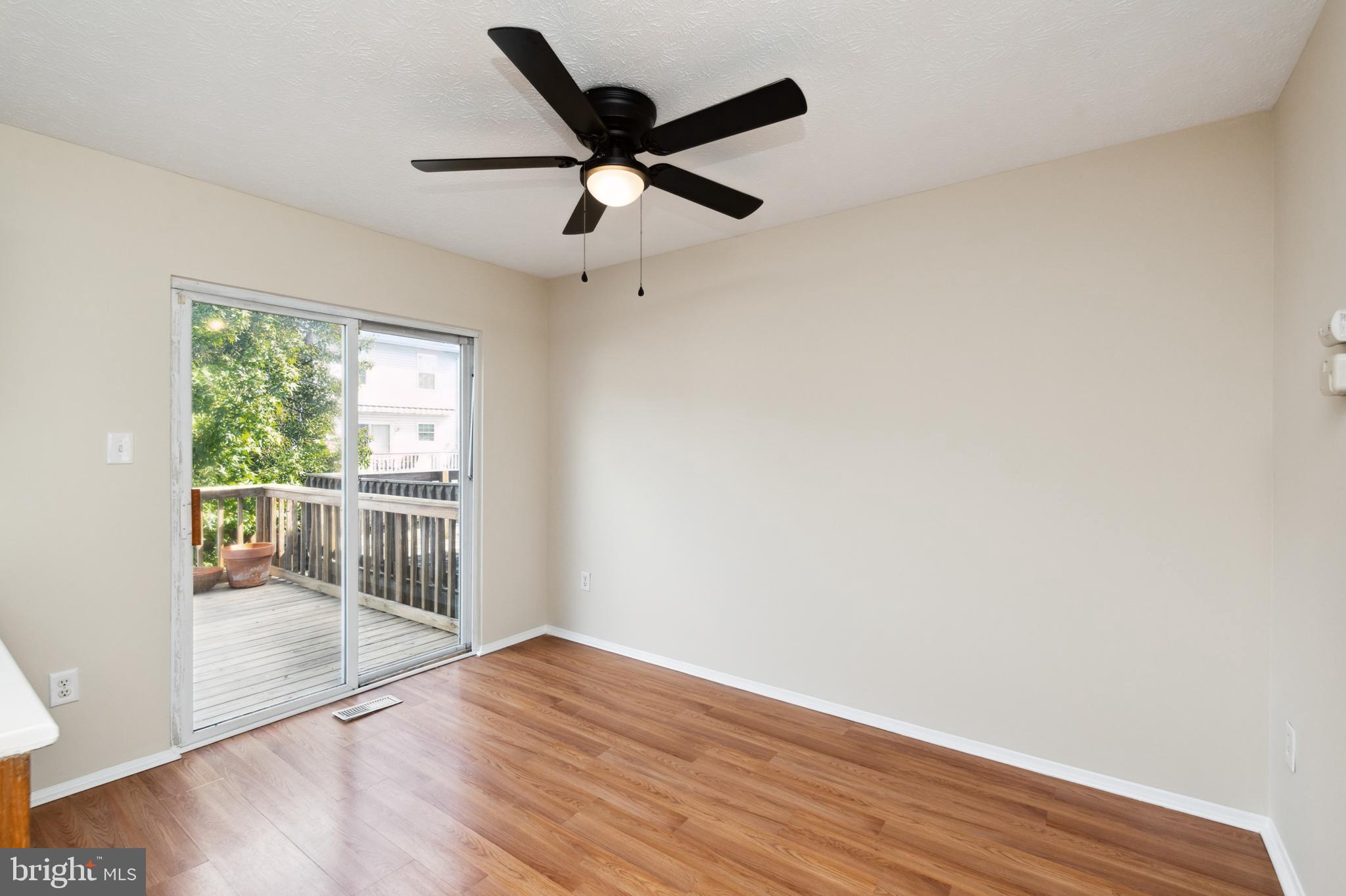4041 Issacs Road Middle River, MD 21220 - Photo 11 of 36 a view of a livingroom with wooden floor and a ceiling fan